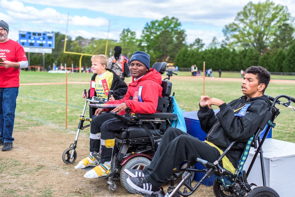 Group of people with wheelchairs at an outdoor community event