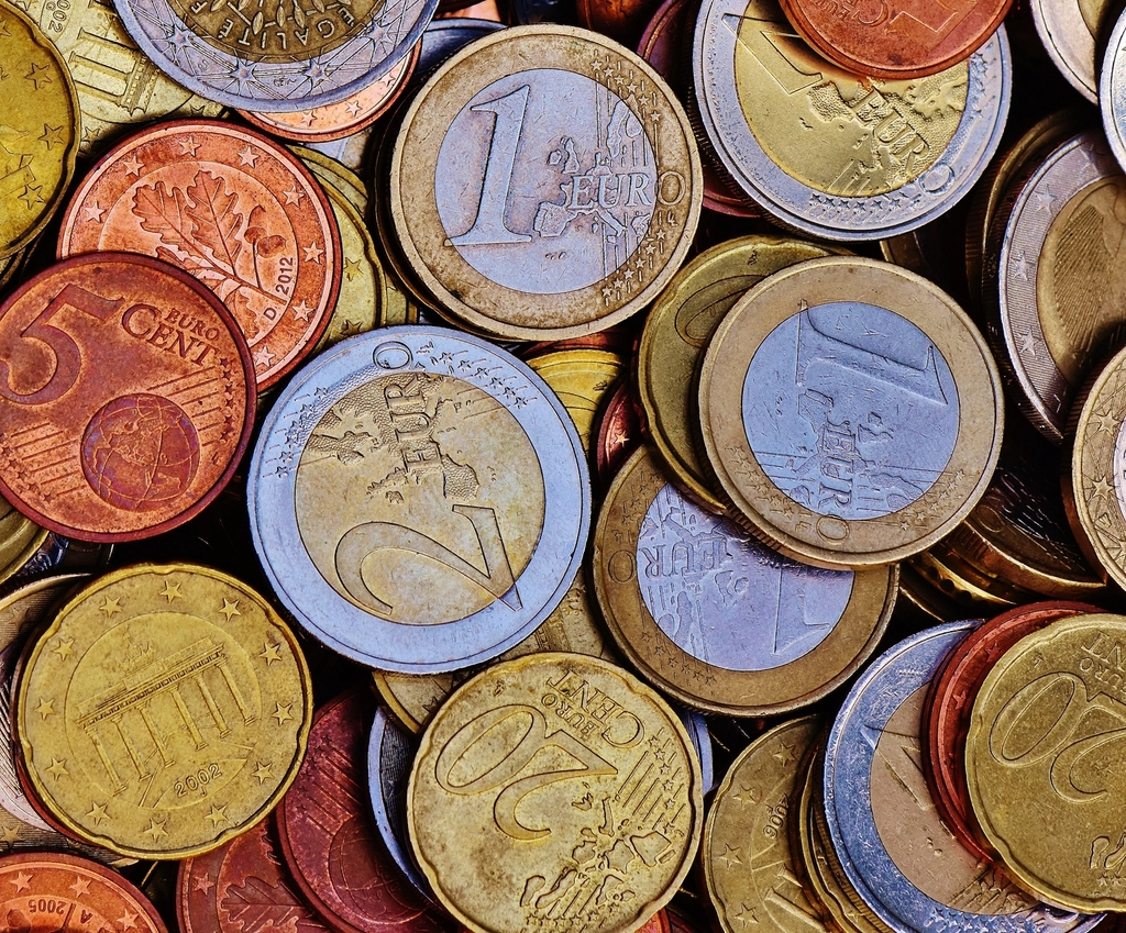 Assortment of coins representing pricing and cost